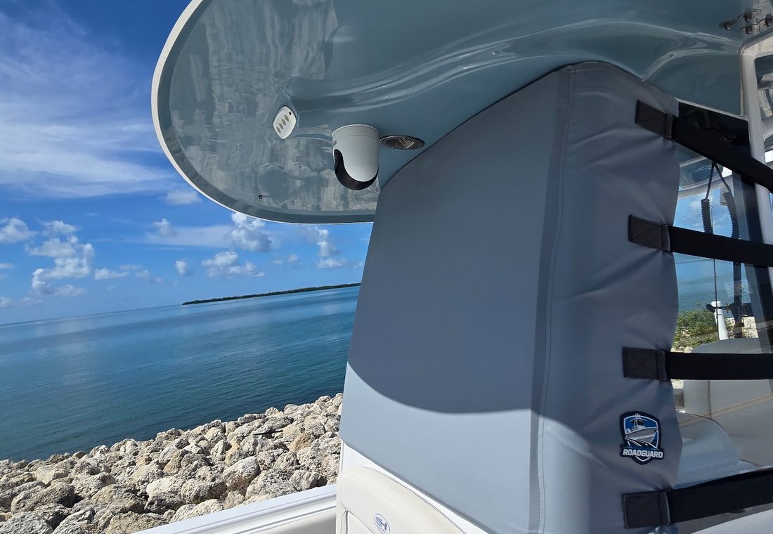Gray Marine RoadGuard windshield cover installed beside blue coastal water