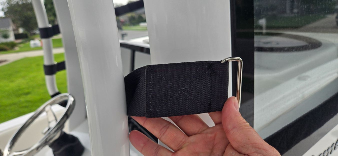 Hand demonstrating Marine RoadGuard strap around windshield support post